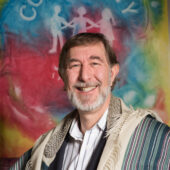 photograph of Rabbi Greg Wolfe and middle-aged man with dark hair a salt and pepper beard and mustache and a welcoming smile